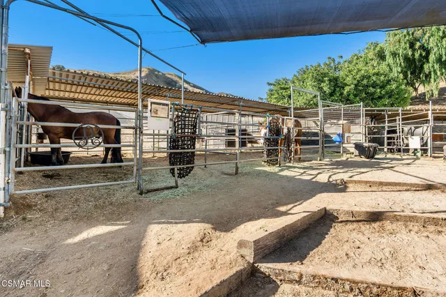 a view of a patio with a table and chairs under an umbrella
