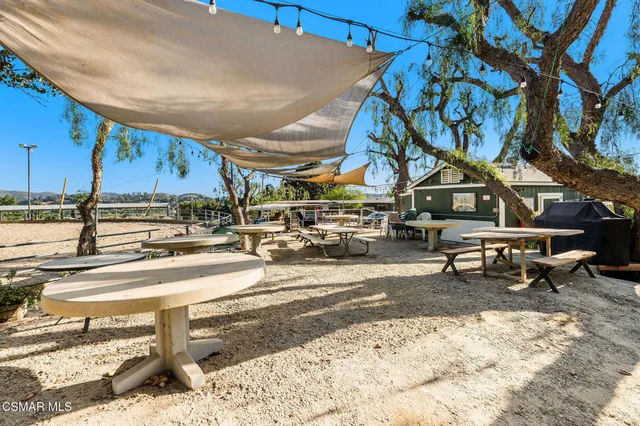a view of a patio with a table and chairs under an umbrella