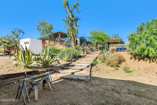 a view of a house with wooden fence