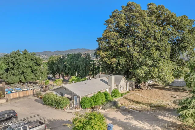 a aerial view of a house with garden space and street view