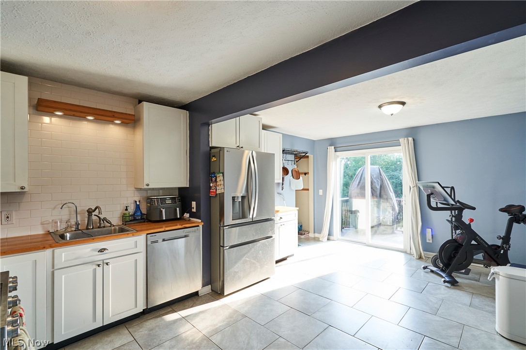 6586 Red Brush Road Ravenna, OH 44266 - Photo 6 of 27 Kitchen with tile floor a pantry closet and slider to a deck