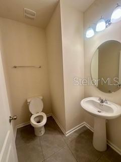 163 Redbud Road Palm Coast, FL 32137 - Photo 11 of 29 a bathroom with a sink toilet and a mirror