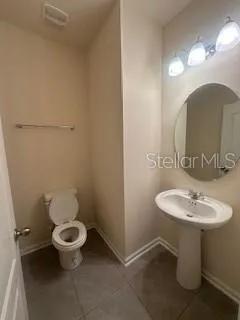 a bathroom with a sink toilet and a mirror