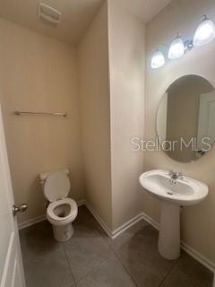 163 Redbud Road Palm Coast, FL 32137 - Photo 12 of 29 a bathroom with a sink toilet and a mirror