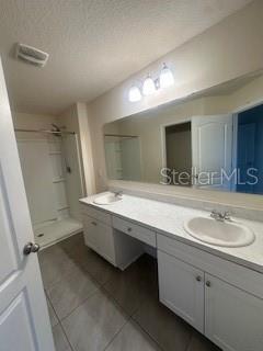 163 Redbud Road Palm Coast, FL 32137 - Photo 19 of 29 a bathroom with a double vanity sink and mirror with shower