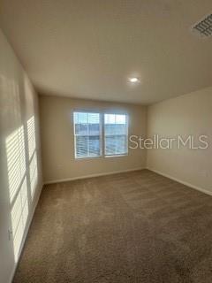 163 Redbud Road Palm Coast, FL 32137 - Photo 23 of 29 an empty room with windows