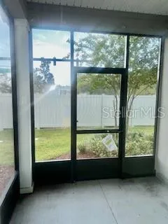 an empty room with large windows