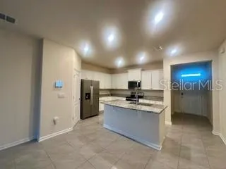 a kitchen with refrigerator and sink