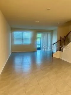 a view of a room with wooden floor and a window