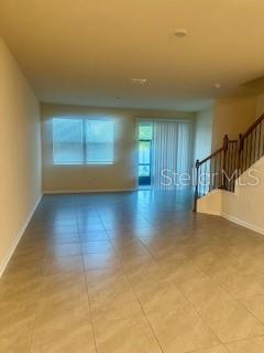 163 Redbud Road Palm Coast, FL 32137 - Photo 7 of 29 a view of a room with wooden floor and a window