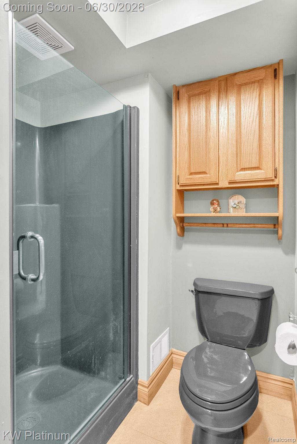 2235 South Lake Shore Road Harbor Beach, MI 48441 - Photo 48 of 99 Three-quarter bathroom featuring a glass-enclosed shower with gray base, wood-finish flooring, a gray toilet, and light-tone wood cabinetry with open shelving