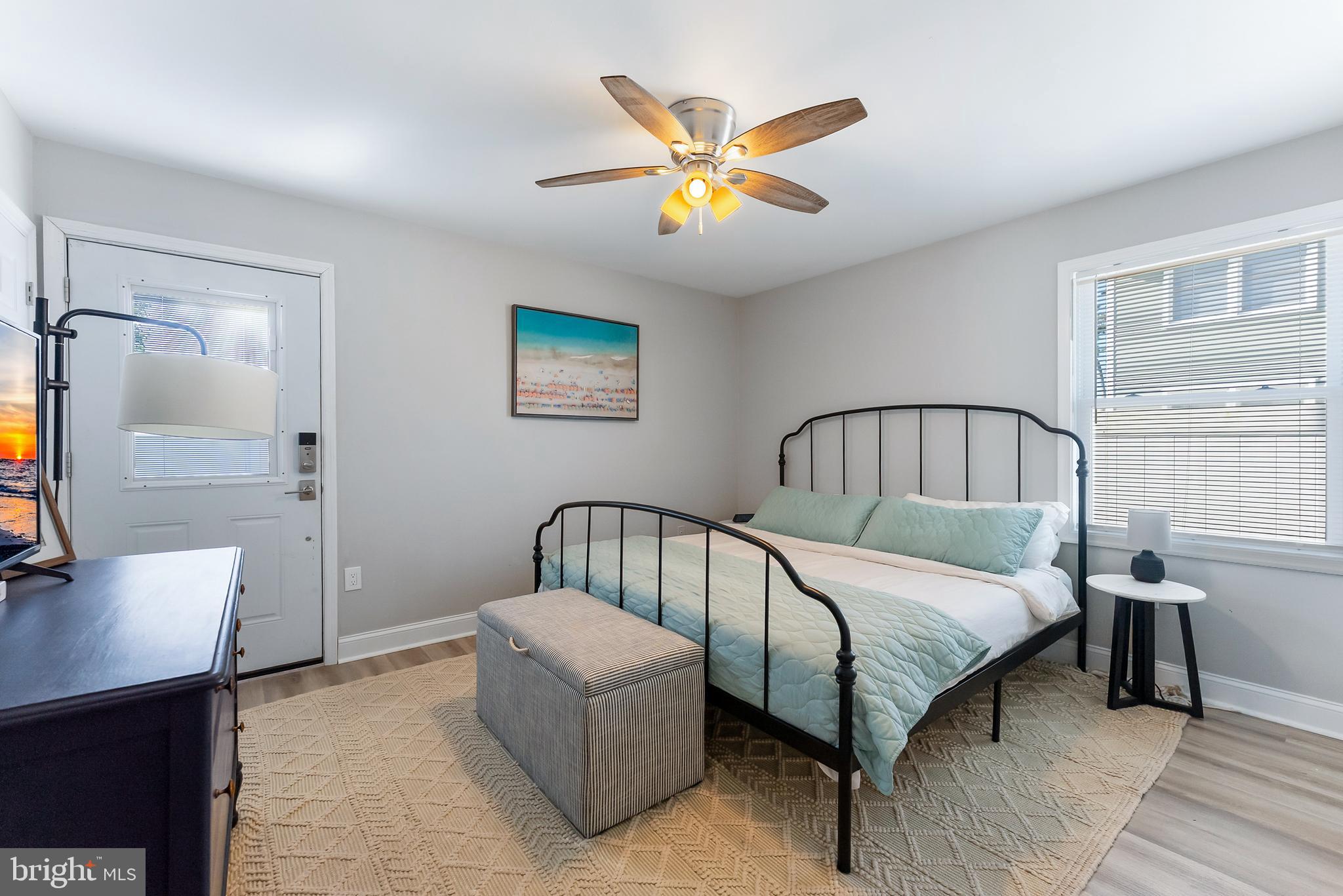 12 Lighthouse Drive, Unit A Brigantine, NJ 08203 - Photo 17 of 32 a bedroom with a bed and a chandelier