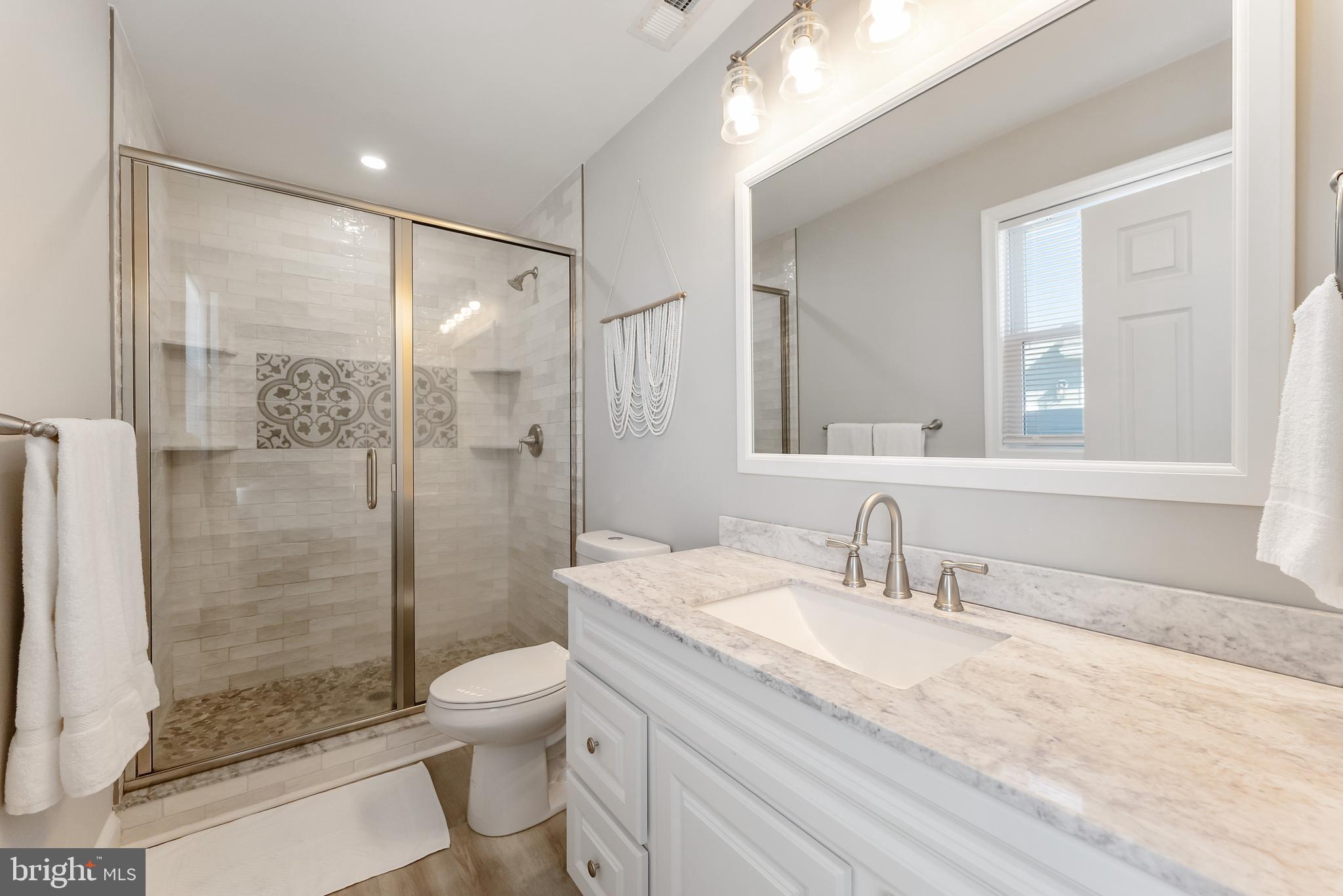 12 Lighthouse Drive, Unit A Brigantine, NJ 08203 - Photo 19 of 32 a bathroom with a granite countertop sink toilet and shower