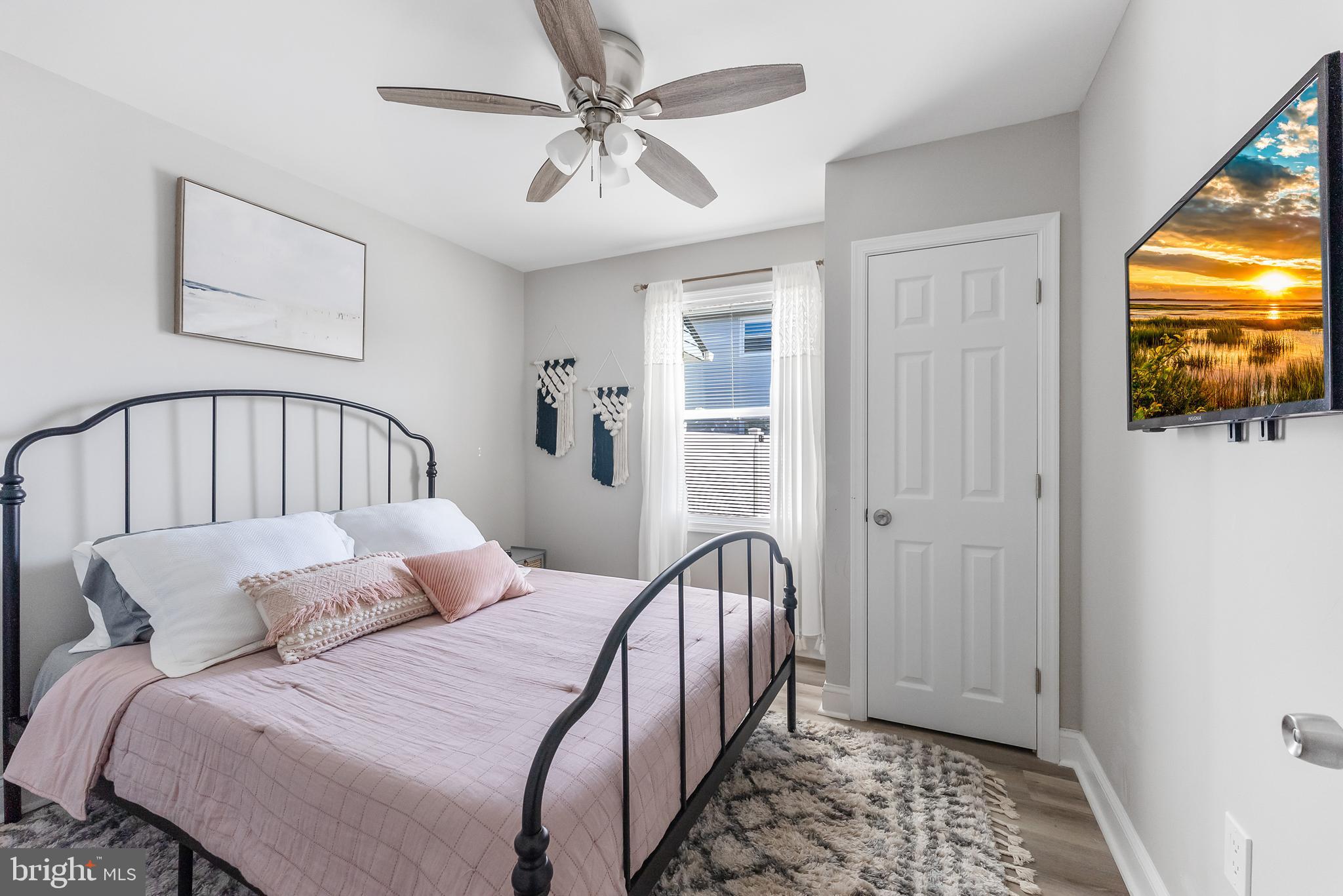 12 Lighthouse Drive, Unit A Brigantine, NJ 08203 - Photo 24 of 32 a bedroom with a bed and a tv
