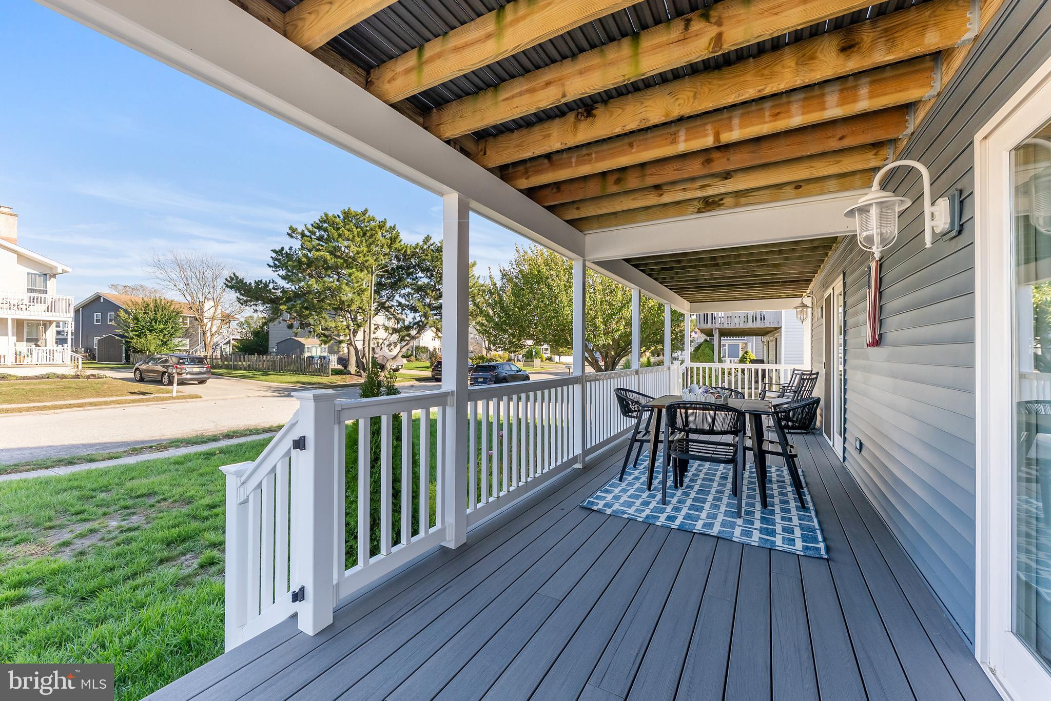 12 Lighthouse Drive, Unit A Brigantine, NJ 08203 - Photo 30 of 32 a view of a patio with table and chairs and wooden floor