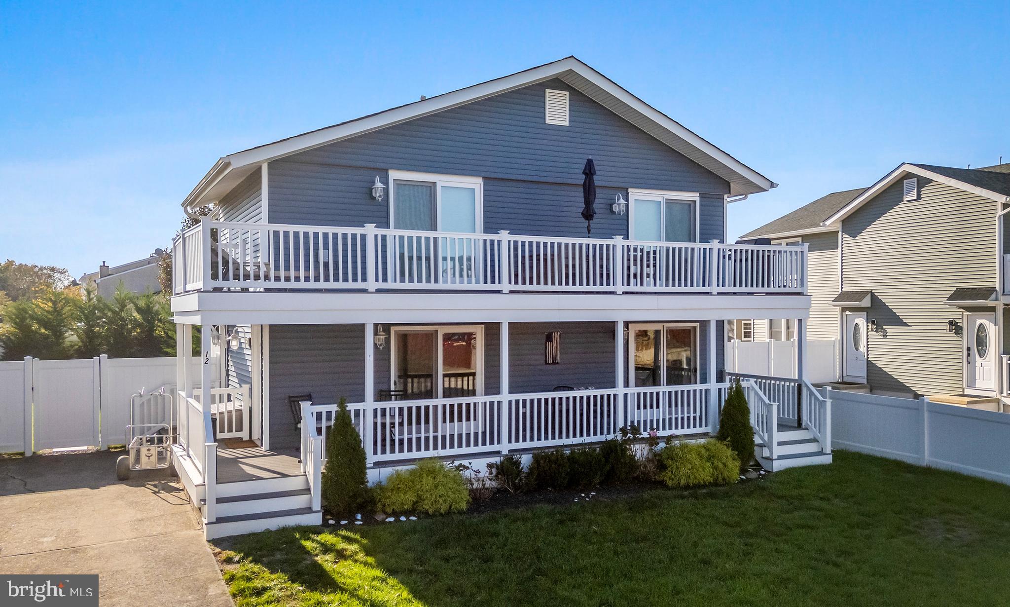 12 Lighthouse Drive, Unit A Brigantine, NJ 08203 - Photo 5 of 32 a view of a house with a yard and deck