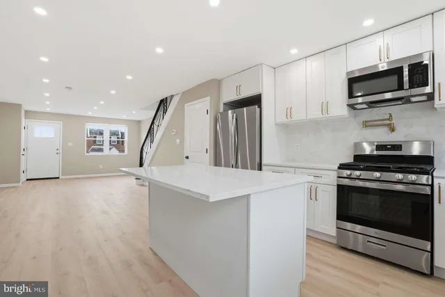 a kitchen with a stove and a microwave