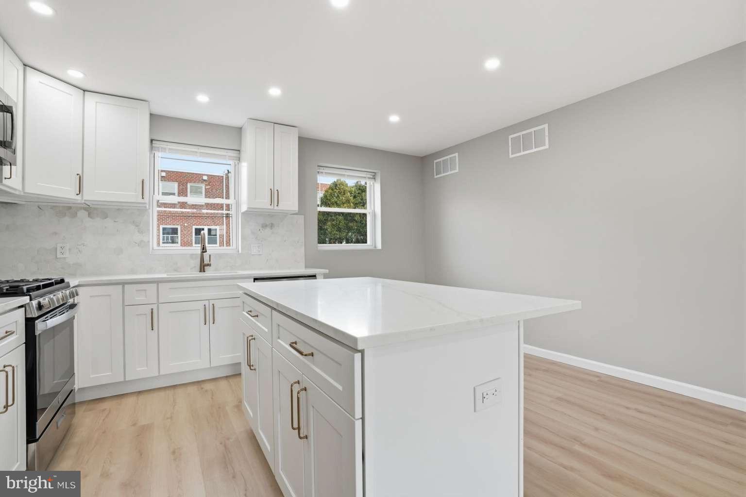 8653 Rugby Street Philadelphia, PA 19150 - Photo 13 of 45 a kitchen with a sink stove and cabinets