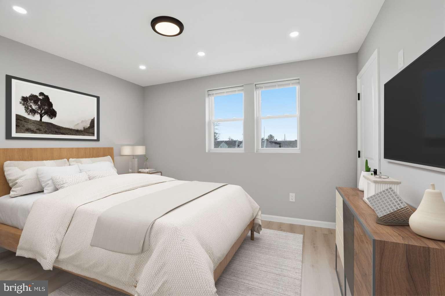 8653 Rugby Street Philadelphia, PA 19150 - Photo 21 of 45 a bedroom with a large bed and a flat screen tv