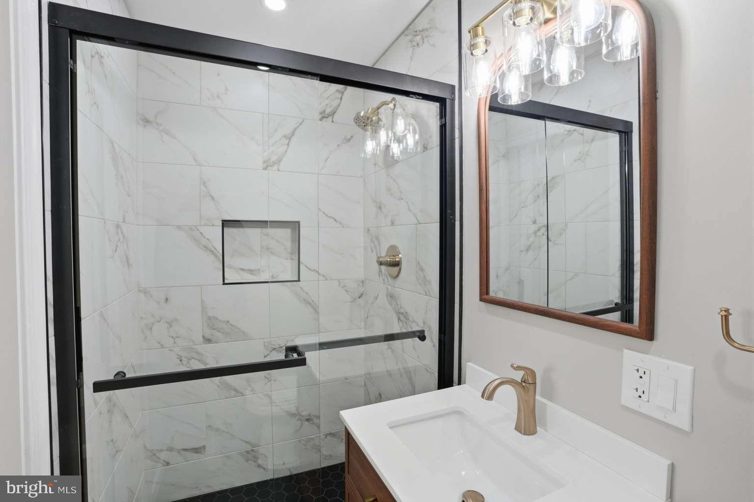 8653 Rugby Street Philadelphia, PA 19150 - Photo 24 of 45 a bathroom with a sink and a mirror