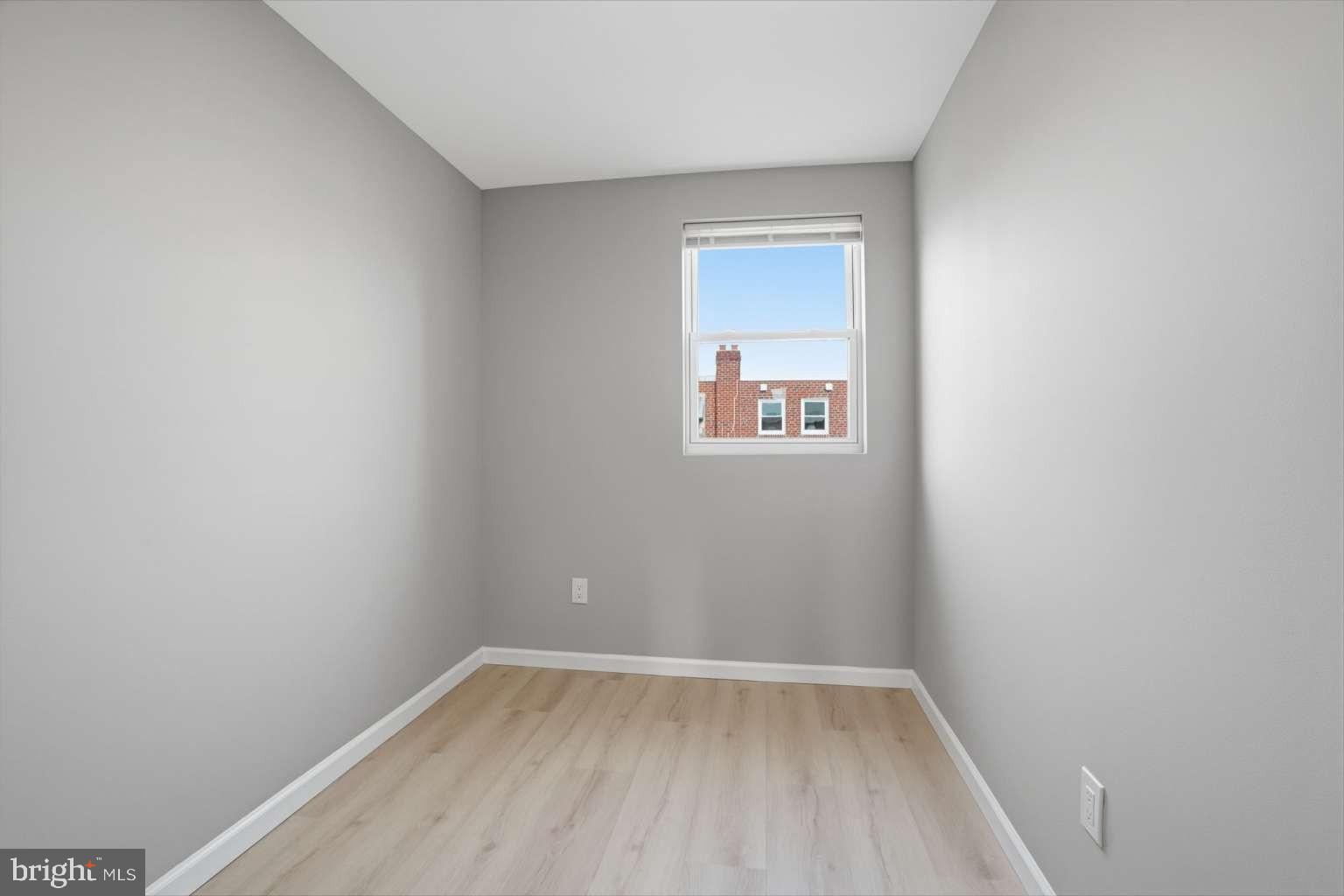 8653 Rugby Street Philadelphia, PA 19150 - Photo 28 of 45 a view of an empty room with wooden floor and a window