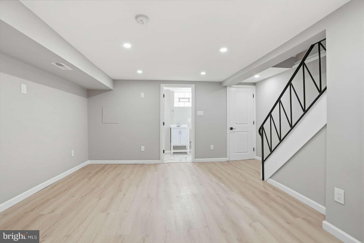 8653 Rugby Street Philadelphia, PA 19150 - Photo 35 of 45 a view of an empty room with wooden floor and stairs