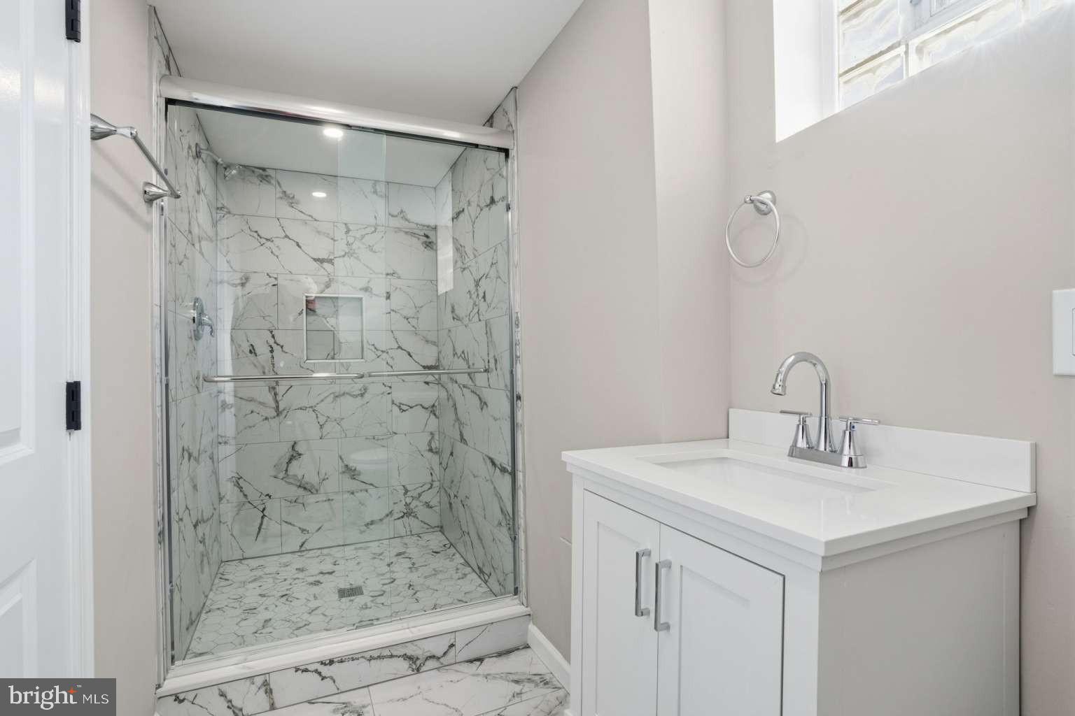 8653 Rugby Street Philadelphia, PA 19150 - Photo 36 of 45 a bathroom with a sink shower and a mirror