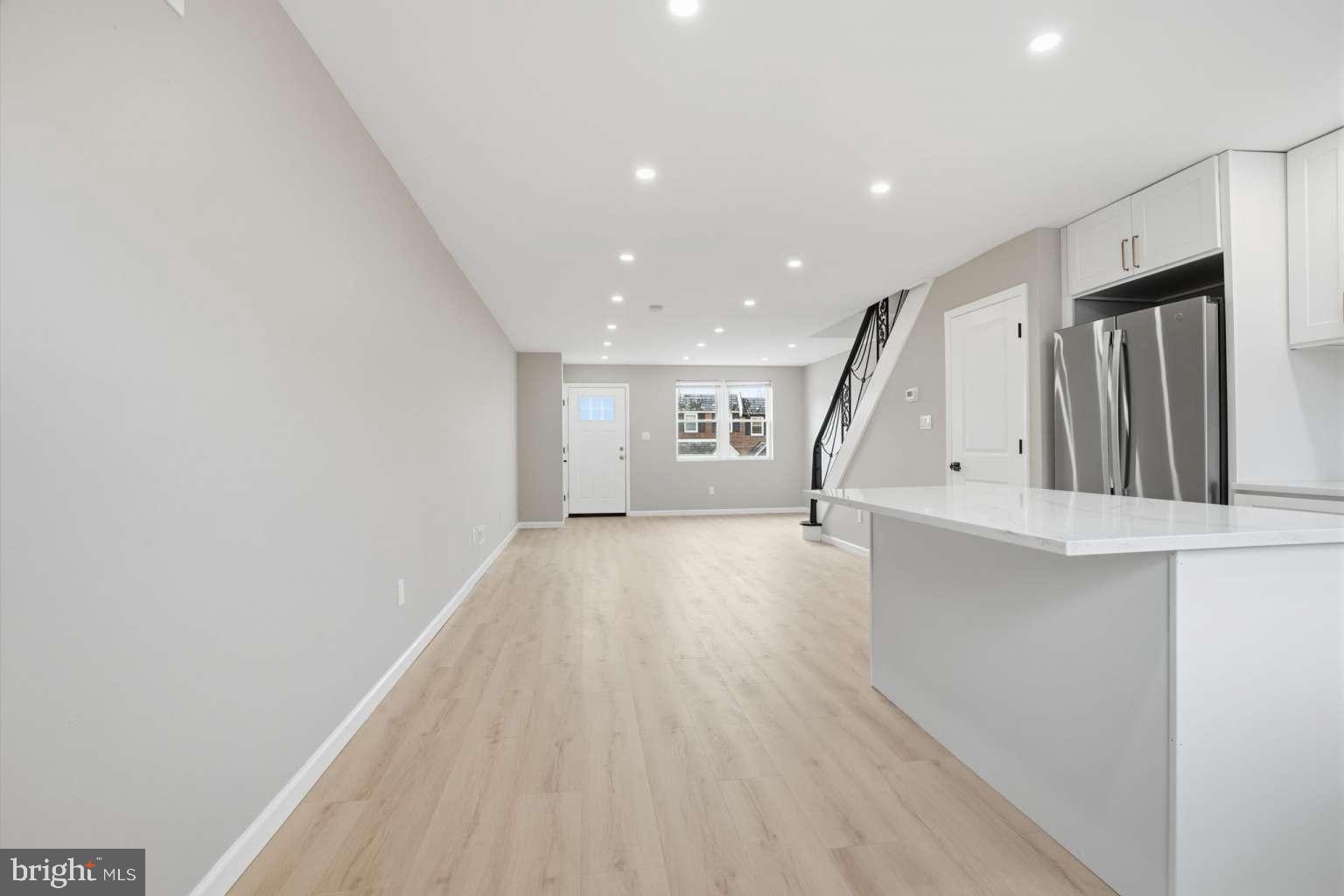 8653 Rugby Street Philadelphia, PA 19150 - Photo 10 of 45 a view of an empty room with wooden floor and stairs