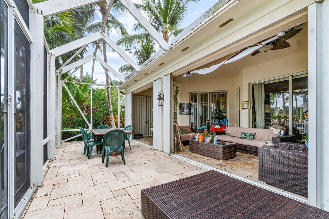7580 Red River Road West Palm Beach, FL 33411 - Photo 32 of 69 a building outdoor space with patio furniture and wooden floor