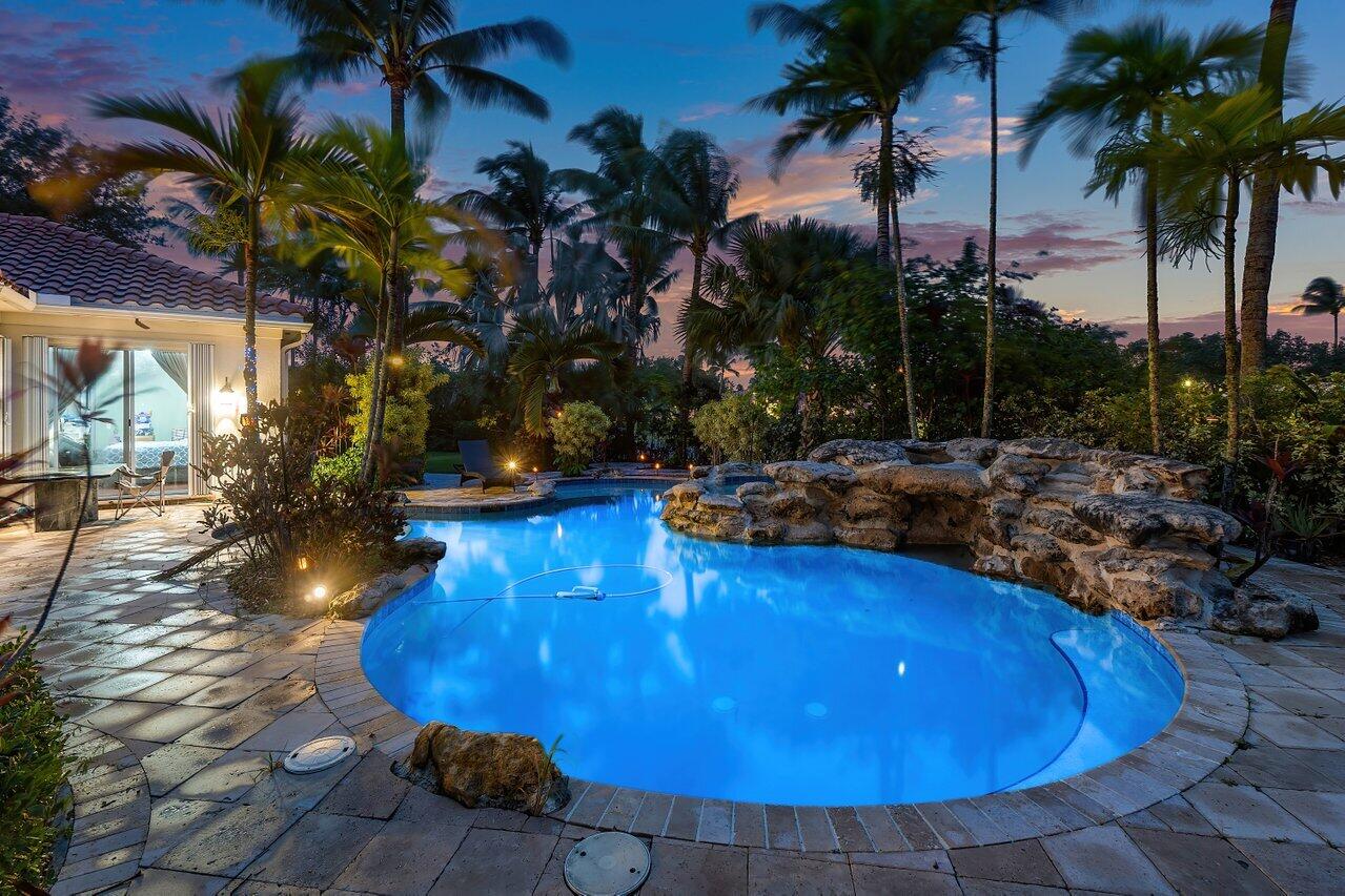 7580 Red River Road West Palm Beach, FL 33411 - Photo 61 of 69 a view of a swimming pool with a table and chairs