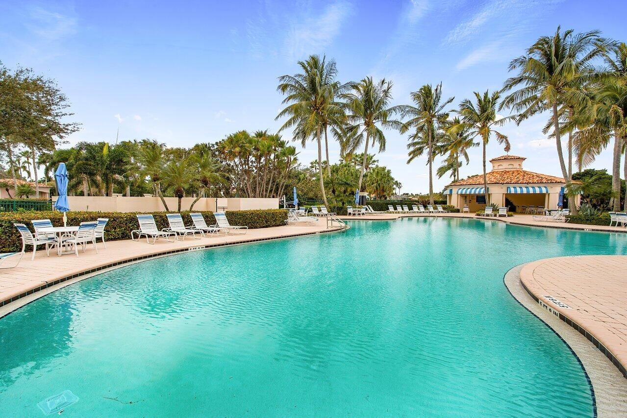 7580 Red River Road West Palm Beach, FL 33411 - Photo 67 of 69 a view of swimming pool with outdoor seating and lake view
