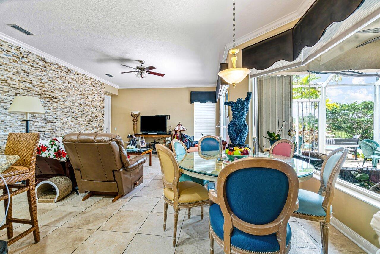 7580 Red River Road West Palm Beach, FL 33411 - Photo 7 of 69 a living room with furniture a fireplace and a floor to ceiling window