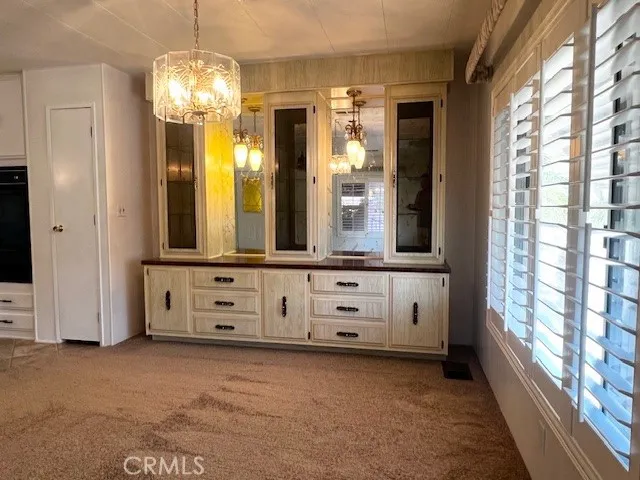 a kitchen with granite countertop a stove a sink and a refrigerator