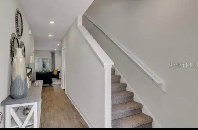 a view of entryway and hall with wooden floor
