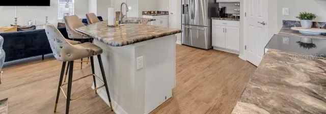 a dining room with furniture and a kitchen view