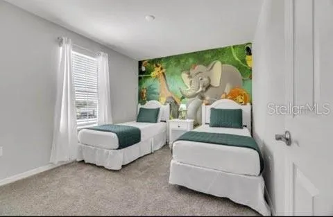 a bedroom with two beds and a large window