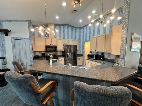 a kitchen with granite countertop lots of counter space dining table and chairs