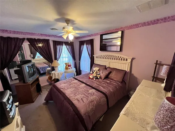 a bed sitting in a bedroom next to a window