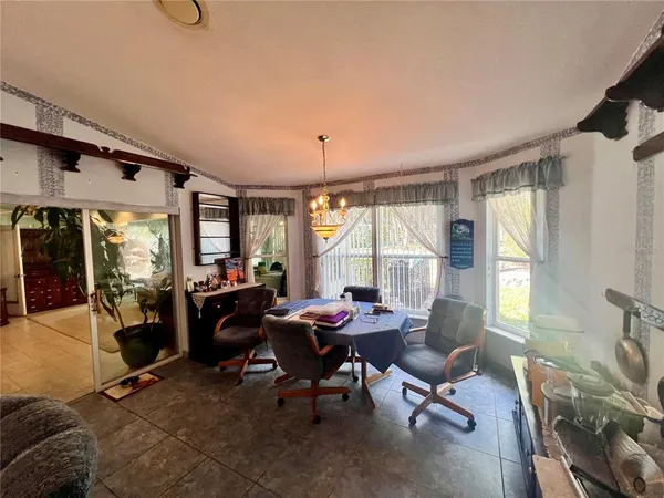 a living room with lots of furniture and a chandelier