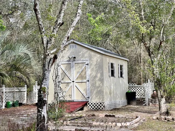a view of a backyard with sitting area