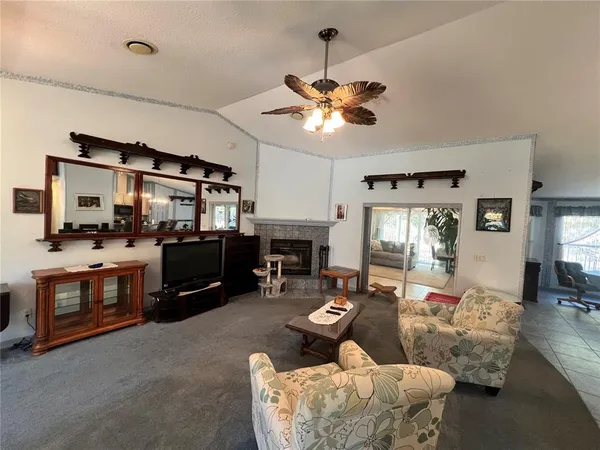 a living room with furniture fireplace and flat screen tv