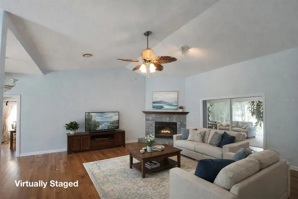 a living room with furniture fireplace and window