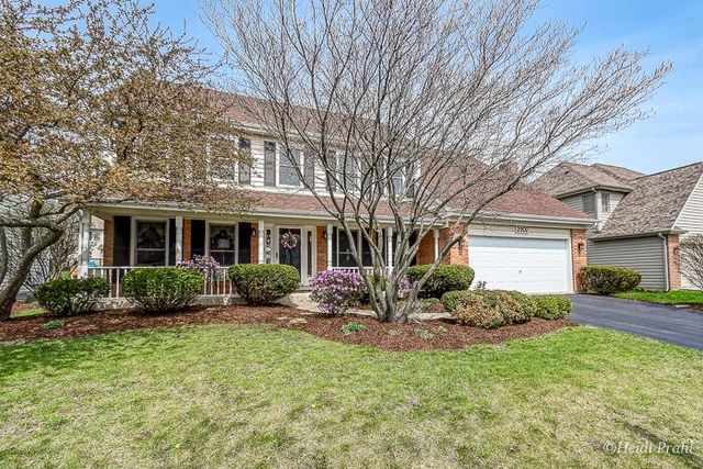 2107 Wicklow Road Naperville, IL 60564 - Photo 1 of 27 a front view of a house with garden and porch