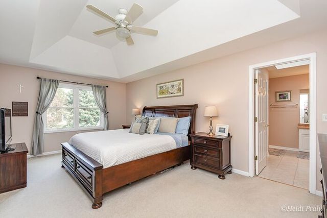2107 Wicklow Road Naperville, IL 60564 - Photo 15 of 27 a bedroom with a bed and a flat screen tv