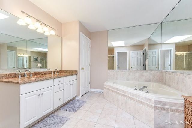 2107 Wicklow Road Naperville, IL 60564 - Photo 16 of 27 a spacious bathroom with a granite countertop tub sink and mirror