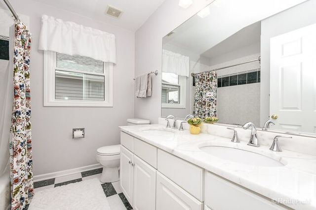 2107 Wicklow Road Naperville, IL 60564 - Photo 20 of 27 a bathroom with a granite countertop sink mirror vanity and toilet