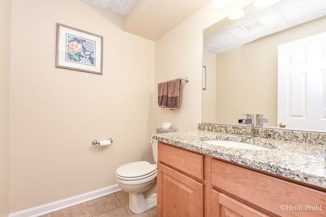 2107 Wicklow Road Naperville, IL 60564 - Photo 26 of 27 a bathroom with a granite countertop sink mirror vanity and toilet