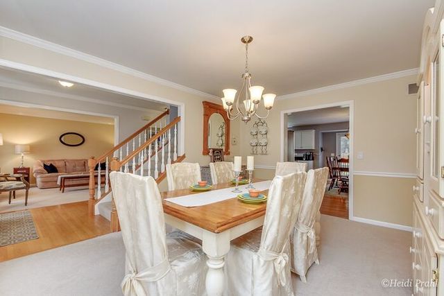 2107 Wicklow Road Naperville, IL 60564 - Photo 3 of 27 a view of a dining room with furniture and chandelier