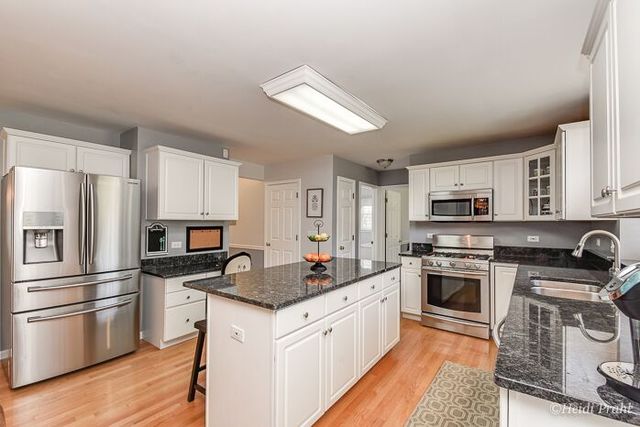 2107 Wicklow Road Naperville, IL 60564 - Photo 6 of 27 a kitchen with a sink stove and refrigerator