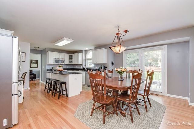 2107 Wicklow Road Naperville, IL 60564 - Photo 7 of 27 a view of a dining room with furniture window and wooden floor